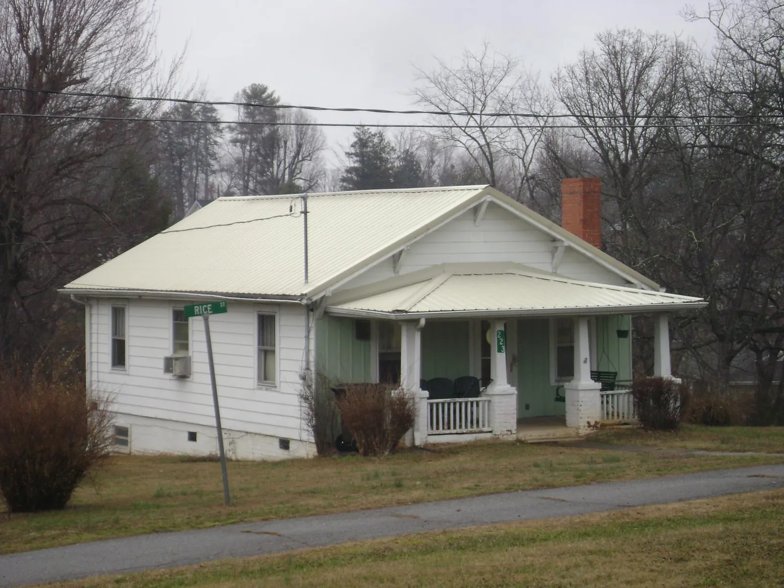 White metal roof on a craftsman bungalow at a street corner in Rochester